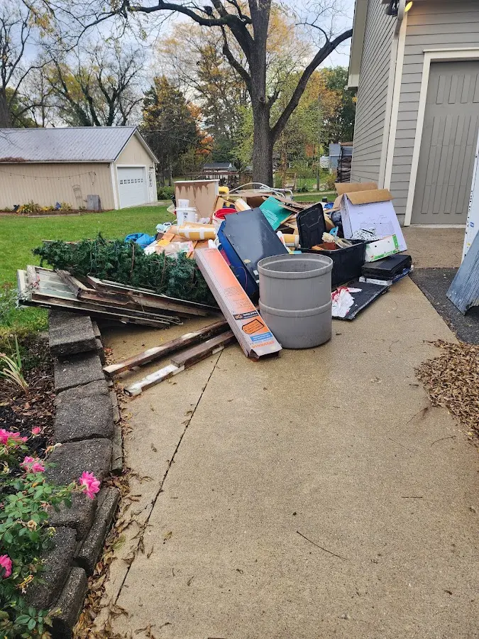 Dumpster being loaded with debris for 3 Yard Dumpster Rental in Webster City